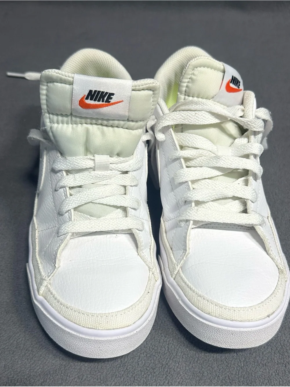 Nike White Mid-Top Sneakers with Orange Swoosh